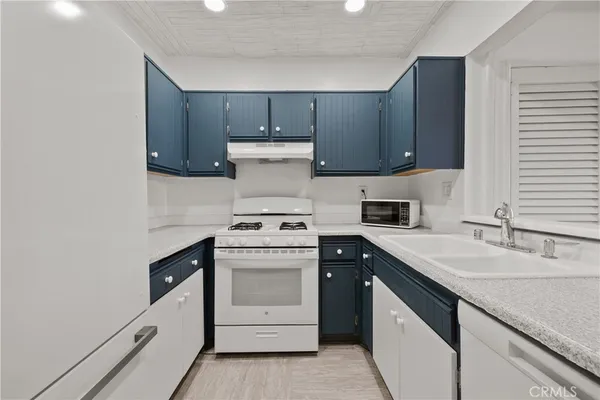 a kitchen with a sink stove and cabinets