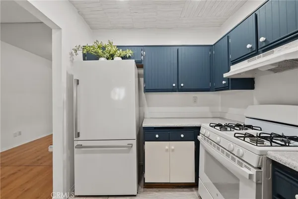 a white refrigerator freezer sitting inside of a kitchen