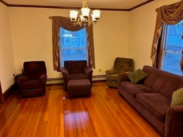 a living room with furniture and wooden floor