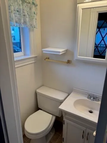 a white toilet sitting next to a bathroom sink