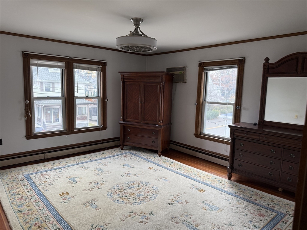 249 Lowell Street Waltham, MA 02453 - Photo 19 of 29 a view of a livingroom with wooden floor and a window