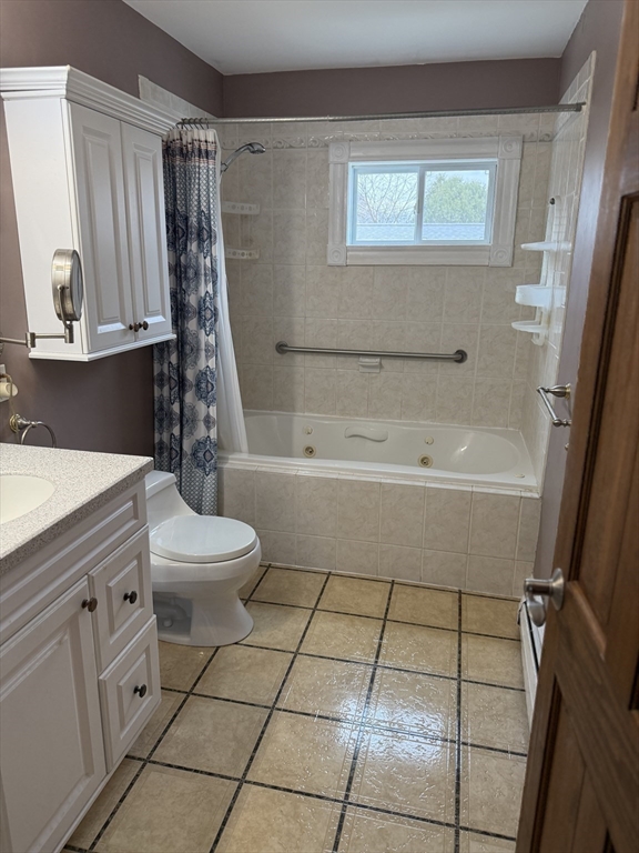 249 Lowell Street Waltham, MA 02453 - Photo 21 of 29 a bathroom with a toilet a sink and a bathtub