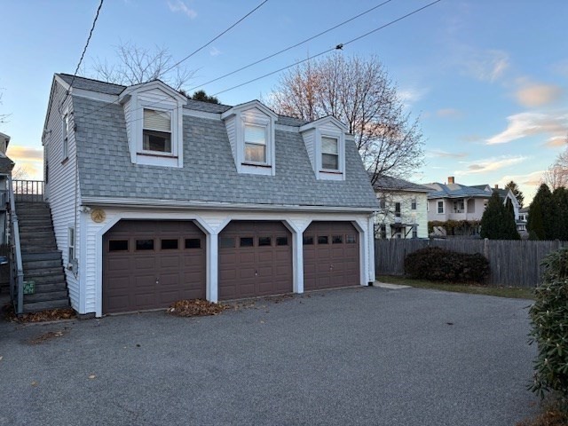 249 Lowell Street Waltham, MA 02453 - Photo 27 of 29 a front view of a house with a yard and garage