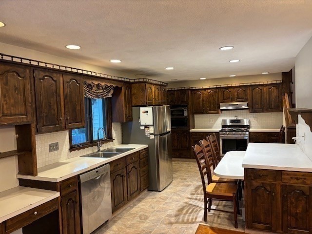 249 Lowell Street Waltham, MA 02453 - Photo 5 of 29 a kitchen with refrigerator and chairs