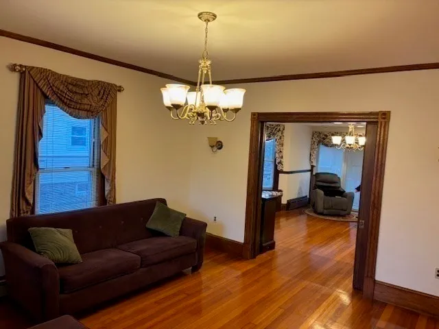a living room with furniture and a chandelier