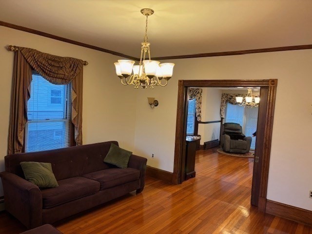 249 Lowell Street Waltham, MA 02453 - Photo 8 of 29 a living room with furniture and a chandelier