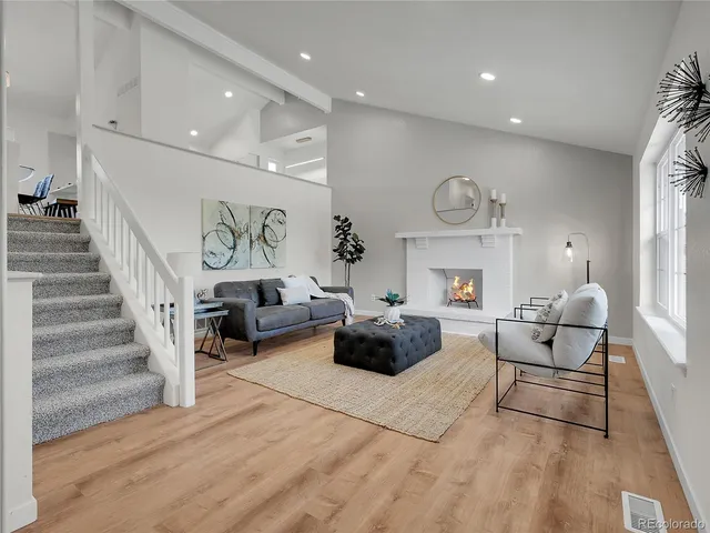 a living room with furniture and a clock