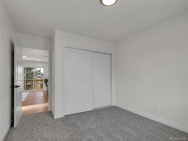 an empty room with glass door and glass door