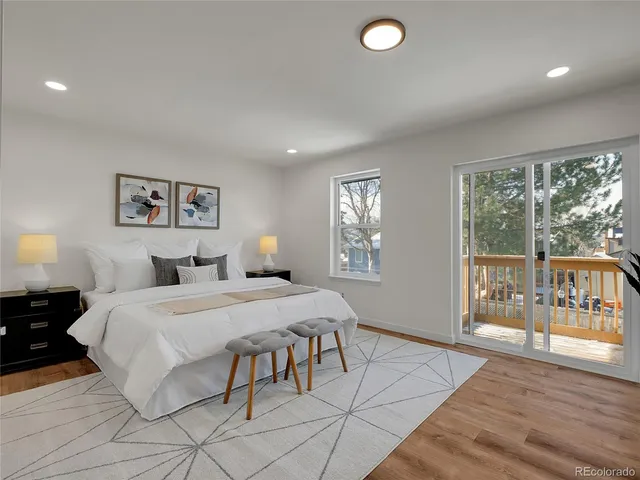 a bedroom with a large bed and a large window