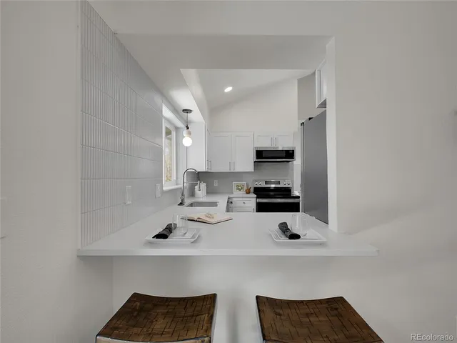 a kitchen with a sink a stove and cabinets
