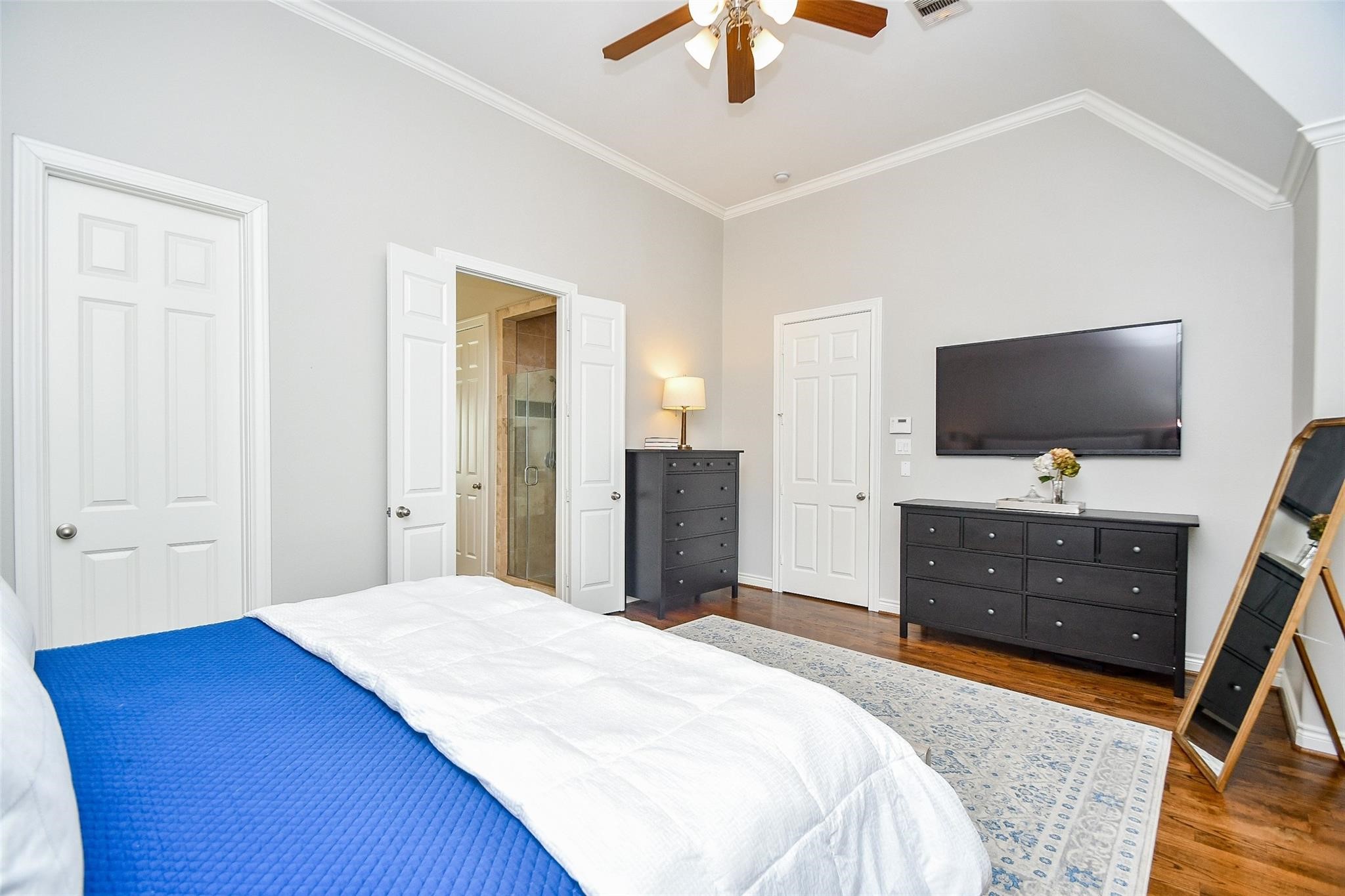 2614 Maxroy Street Houston, TX 77007 - Photo 19 of 32 a bedroom with a bed and a flat tv screen on dresser