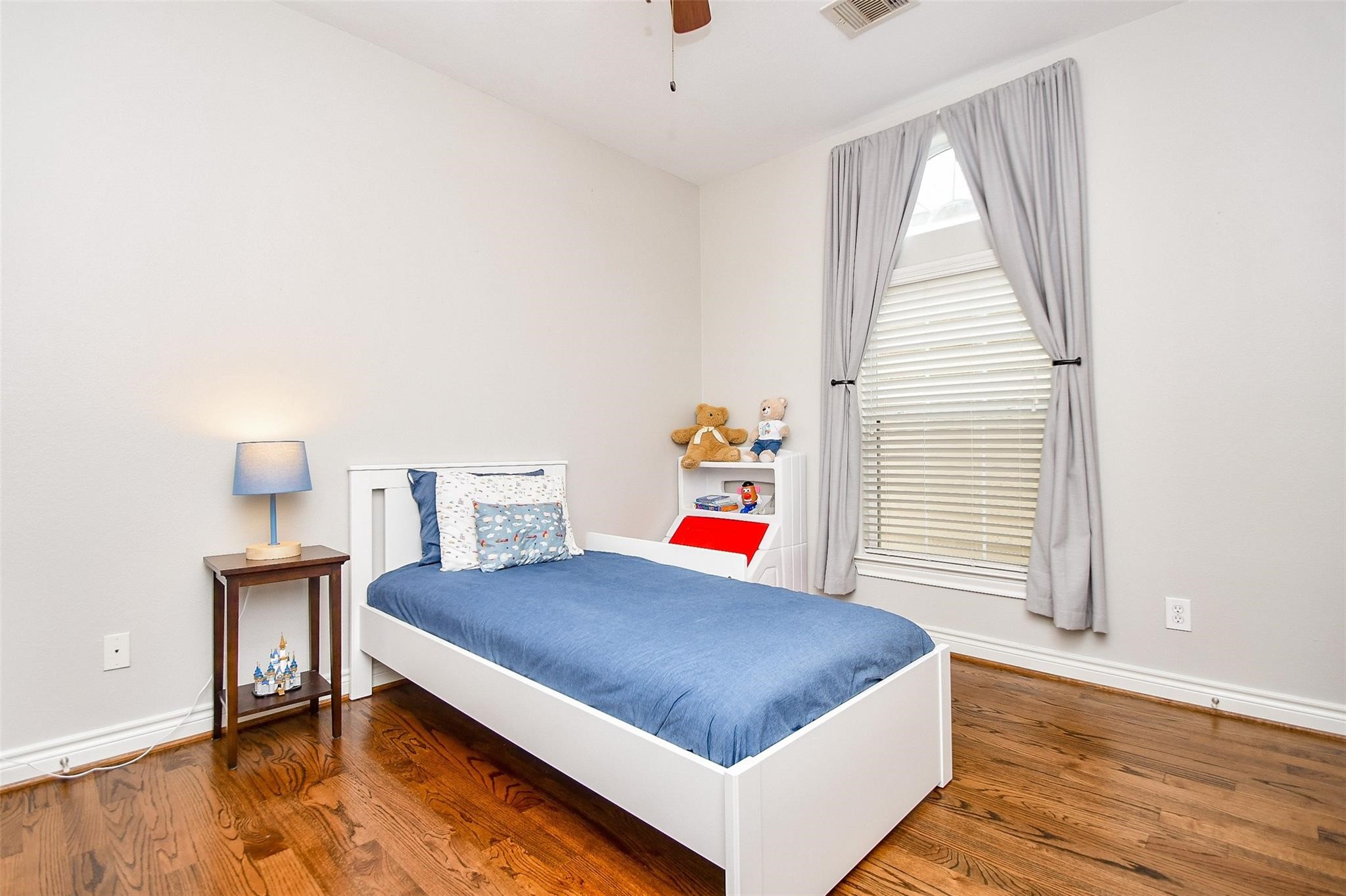 2614 Maxroy Street Houston, TX 77007 - Photo 24 of 32 a bedroom with a bed and a window