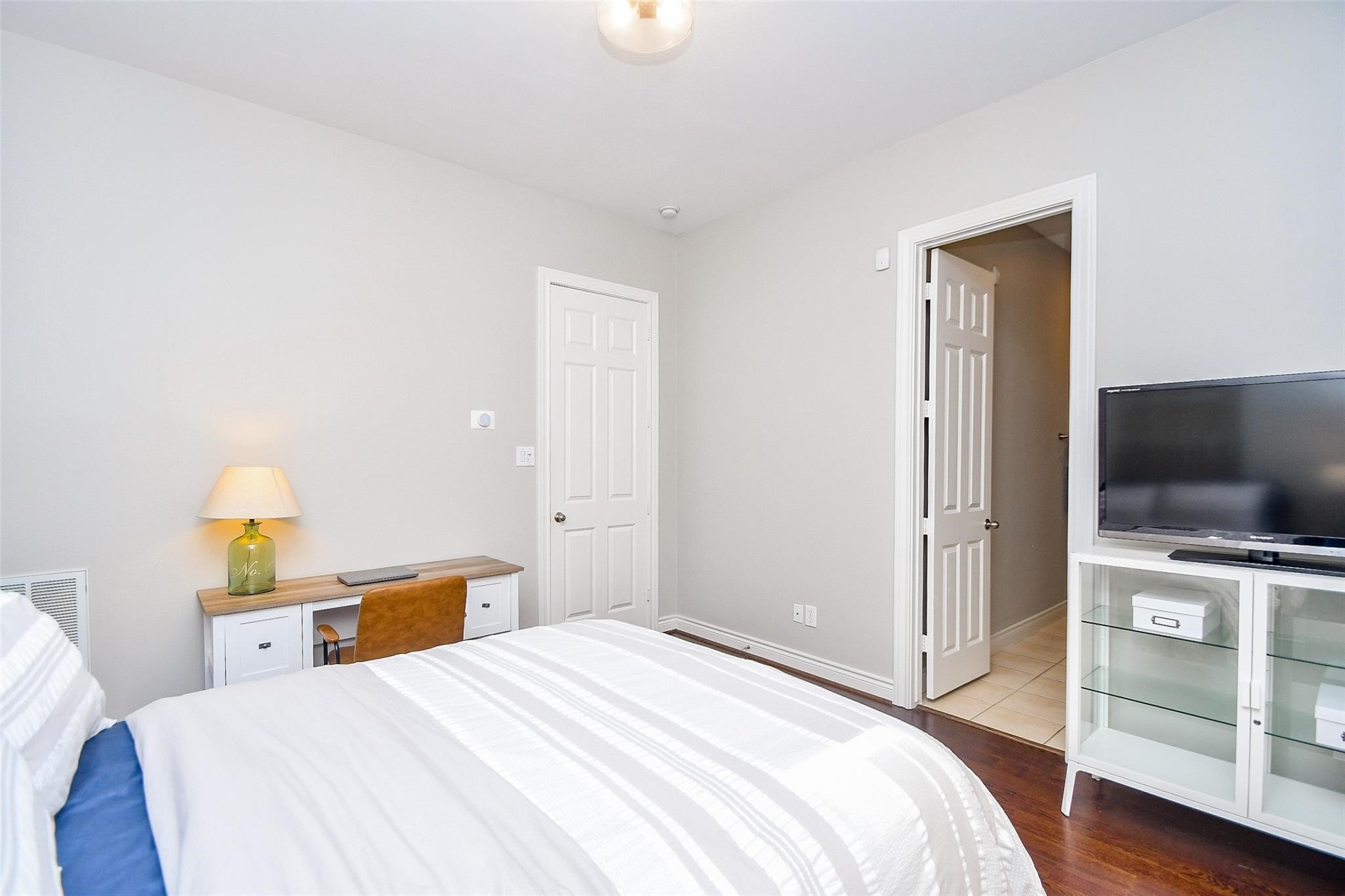 2614 Maxroy Street Houston, TX 77007 - Photo 28 of 32 a bedroom with a bed and a flat screen tv