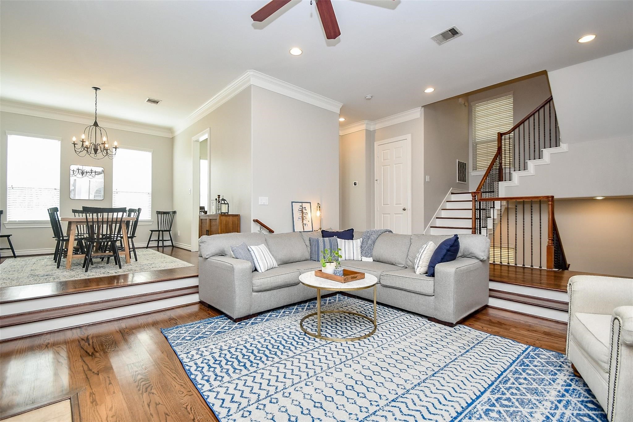 2614 Maxroy Street Houston, TX 77007 - Photo 8 of 32 a living room with furniture a rug and a chandelier