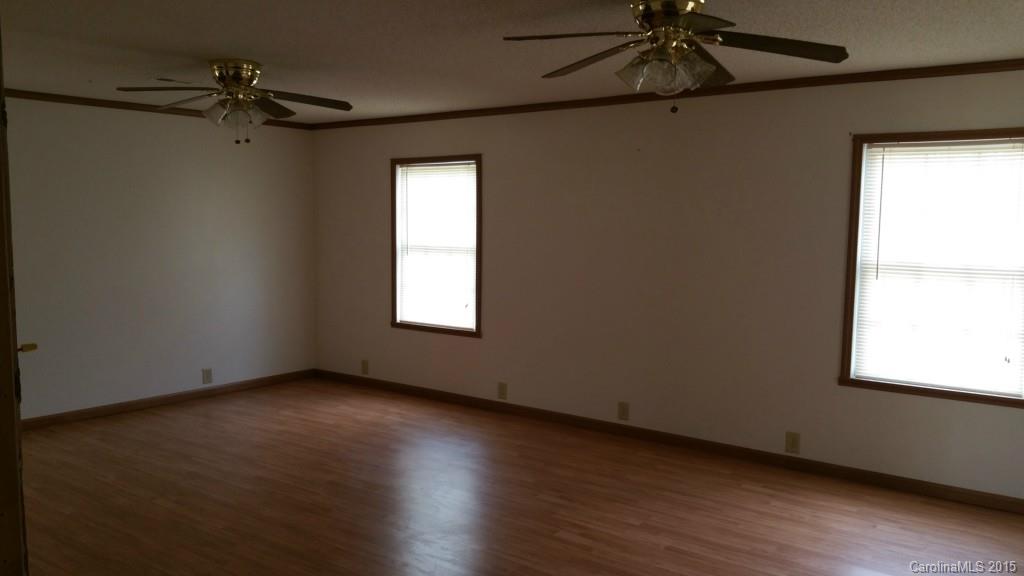 4545 Percival Road Rock Hill, SC 29730 - Photo 10 of 19 a view of an empty room with a window and wooden floor