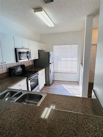 a living room with a couch and a walk in closet