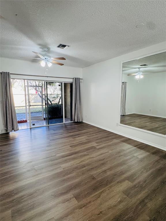12113 Southwest 2nd Street Pembroke Pines, FL 33025 - Photo 13 of 18 an empty room with wooden floor and windows