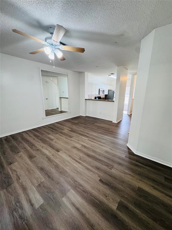 12113 Southwest 2nd Street Pembroke Pines, FL 33025 - Photo 15 of 18 a view of empty room with wooden floor and fan
