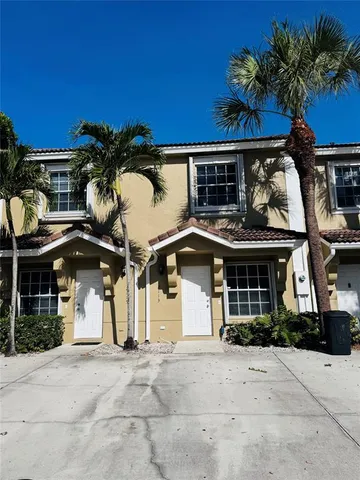 a front view of a house with parking space and a garage