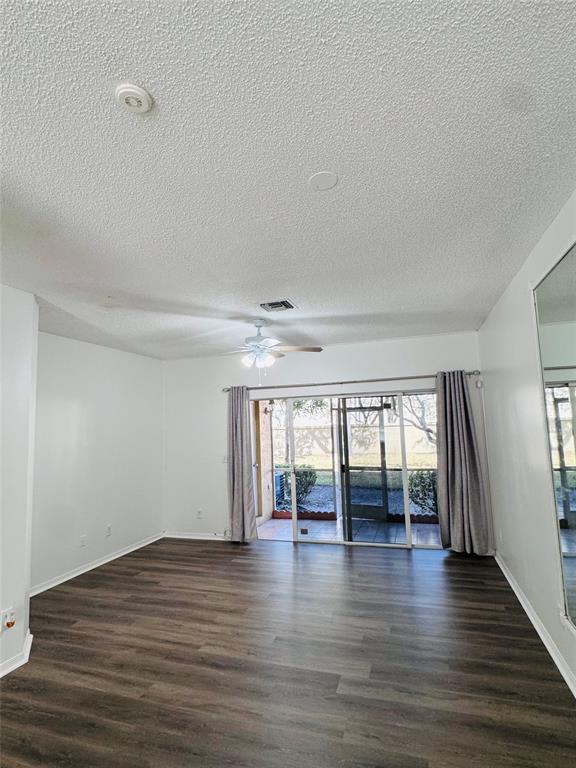 12113 Southwest 2nd Street Pembroke Pines, FL 33025 - Photo 4 of 18 a view of an empty room with wooden floor and a window