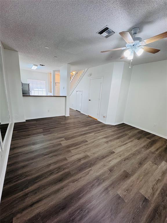 12113 Southwest 2nd Street Pembroke Pines, FL 33025 - Photo 5 of 18 a view of an empty room with wooden floor and a ceiling fan