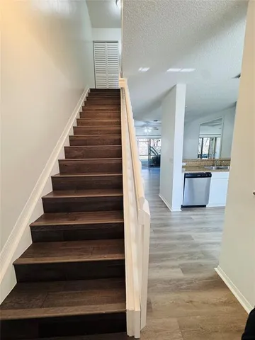 a view of entryway and hall with wooden floor