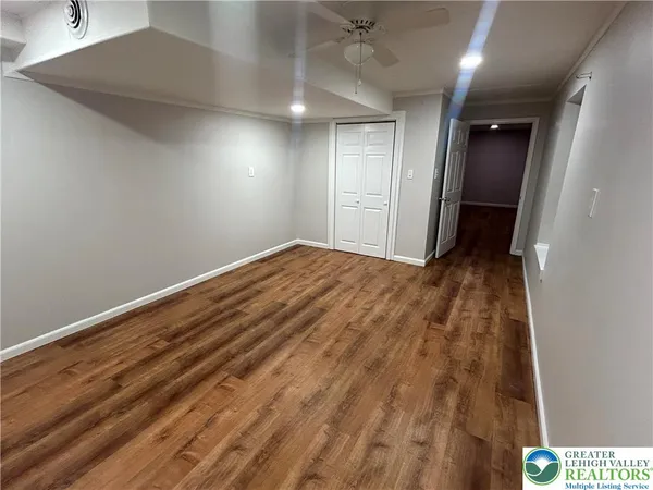 a view of empty room with wooden floor