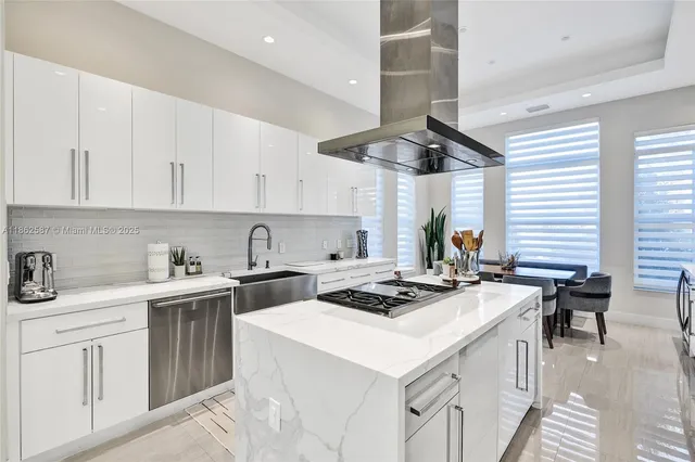 a kitchen with a stove a sink a refrigerator and cabinets