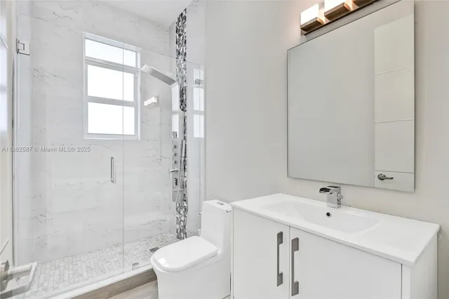 a bathroom with a sink toilet and shower