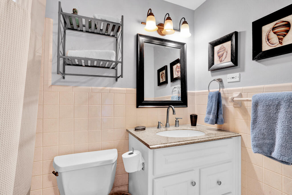 270 9th Street Key Colony Beach, FL 33051 - Photo 12 of 37 a bathroom with a toilet sink and mirror