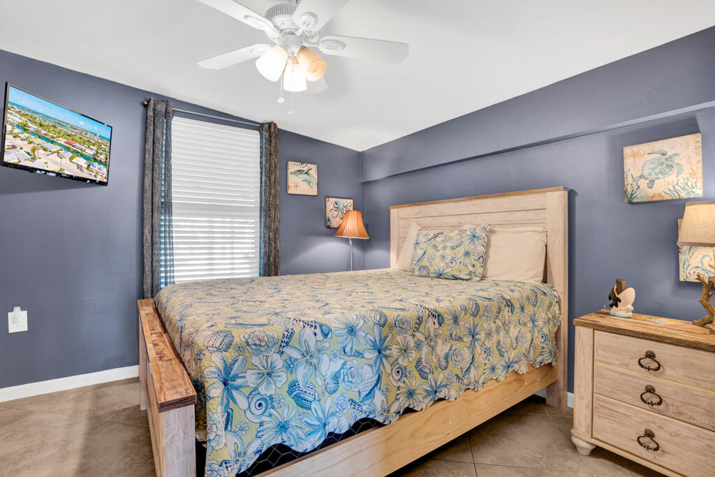 270 9th Street Key Colony Beach, FL 33051 - Photo 14 of 37 a bedroom with a bed and a chandelier