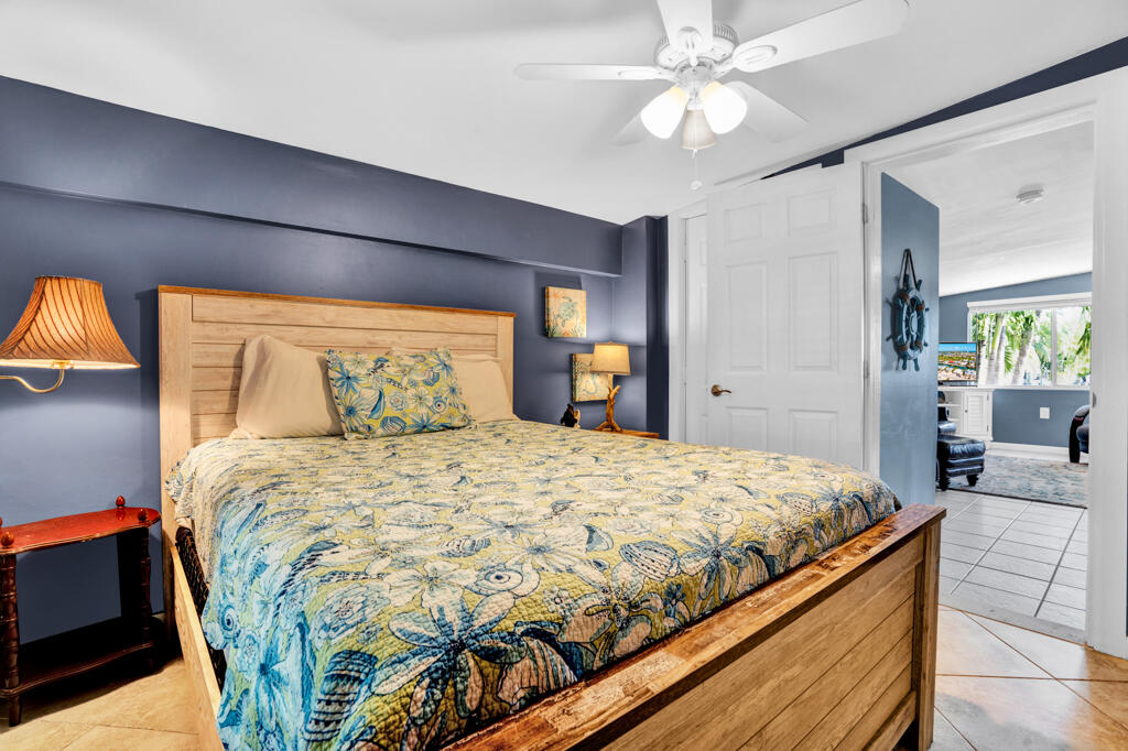 270 9th Street Key Colony Beach, FL 33051 - Photo 15 of 37 a bedroom with a bed and a chandelier