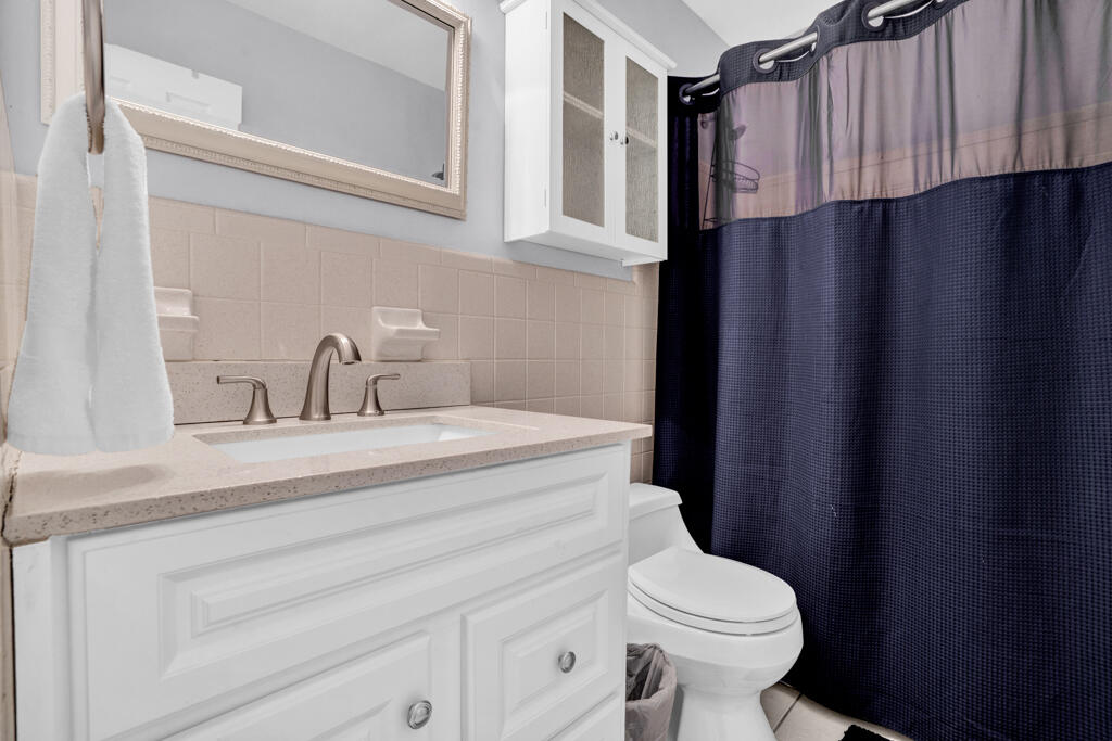 270 9th Street Key Colony Beach, FL 33051 - Photo 16 of 37 a bathroom with a sink a toilet and a mirror