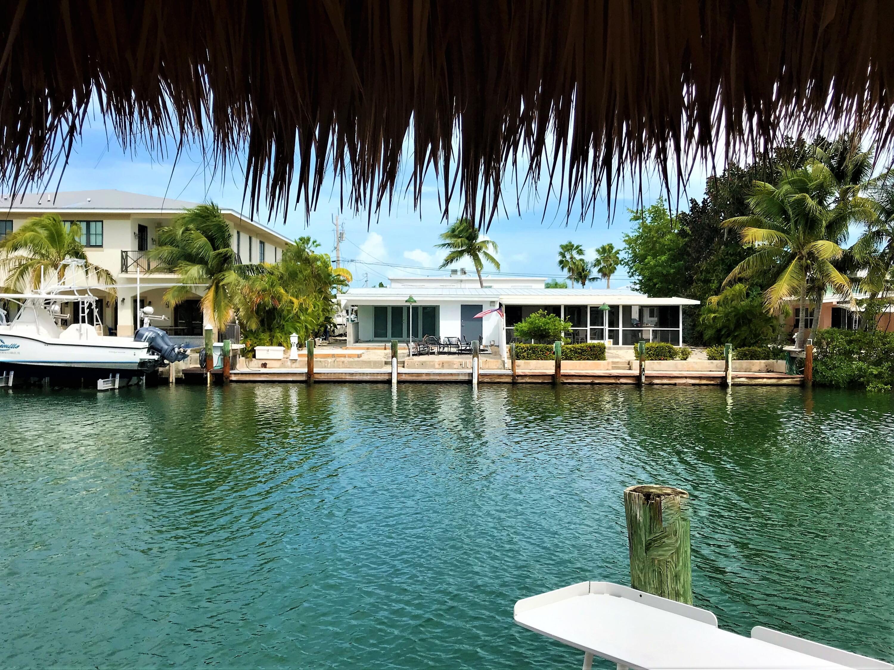 270 9th Street Key Colony Beach, FL 33051 - Photo 23 of 37 a view of a swimming pool with a table and chairs