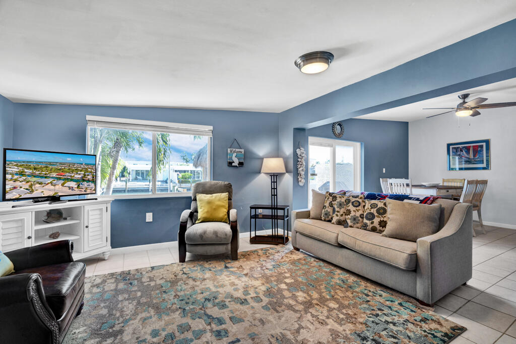 270 9th Street Key Colony Beach, FL 33051 - Photo 3 of 37 a living room with furniture and a flat screen tv