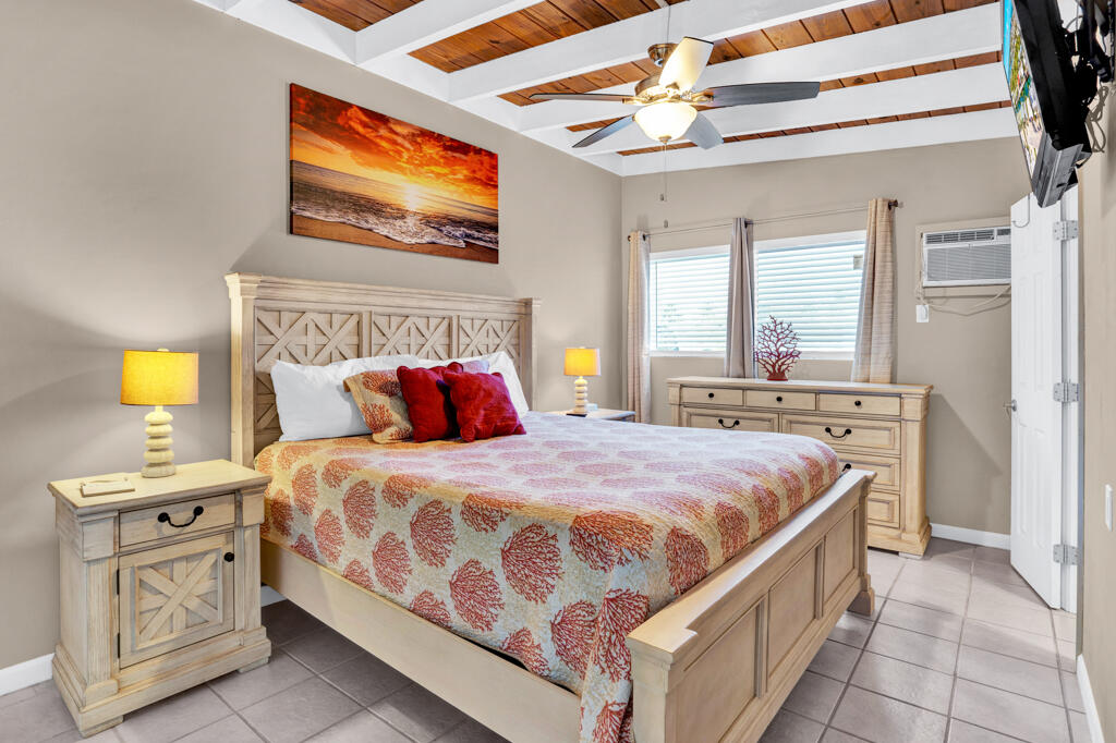 270 9th Street Key Colony Beach, FL 33051 - Photo 10 of 37 a bedroom with a bed a rug and dresser