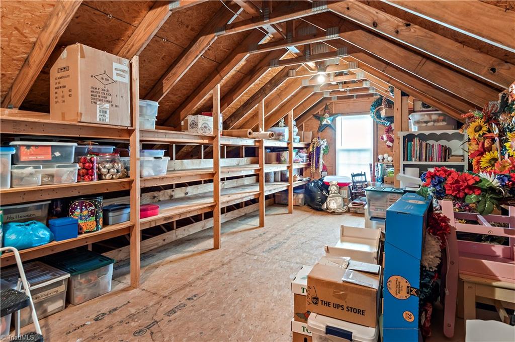 2151 Hickory Tree Road Winston-Salem, NC 27127 - Photo 27 of 31 Huge storage attic space with 22x12 floored and built in shelving - AND it's WALK IN from steps in garage - very handy