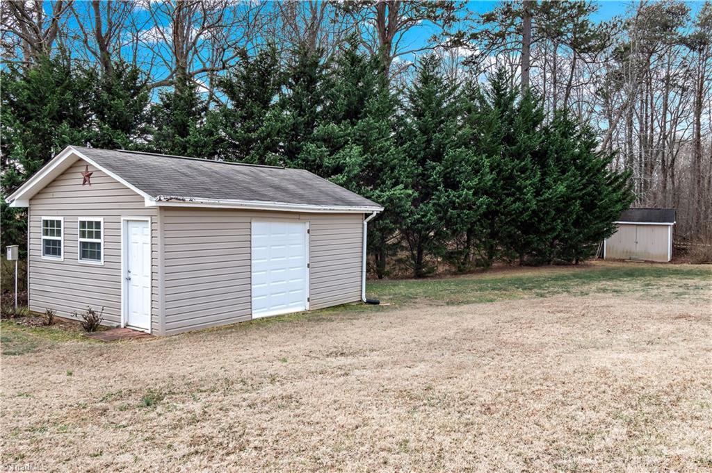 2151 Hickory Tree Road Winston-Salem, NC 27127 - Photo 31 of 31 Two storage buildings on the property with both being on concrete slabs. One has garage door. Great storage and nicely placed on the .92 acre