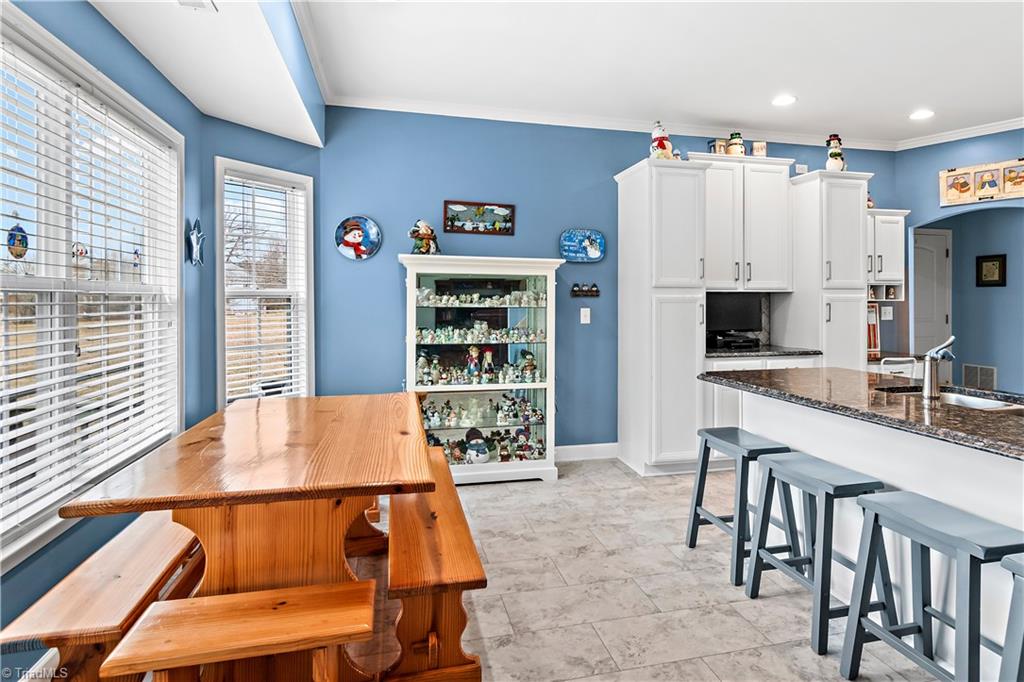 2151 Hickory Tree Road Winston-Salem, NC 27127 - Photo 8 of 31 Breakfast room and kitchen are flooded with natural light. Bar stools at counter allow more space for gatherings