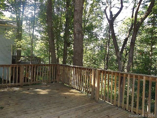27076 Catamaran Drive Tega Cay, SC 29708 - Photo 17 of 22 a view of balcony with wooden fence and trees