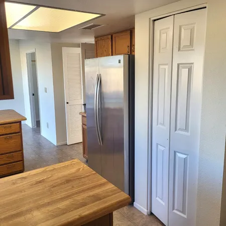 a kitchen with stainless steel appliances a refrigerator and wooden floor