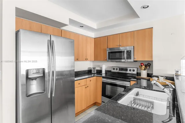 a kitchen with a refrigerator sink and microwave