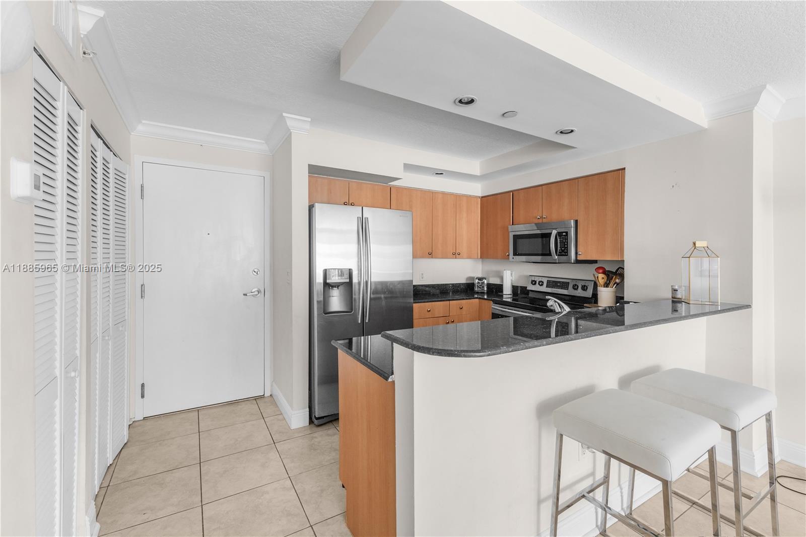 6917 Collins Avenue, Unit 1505 Miami Beach, FL 33141 - Photo 14 of 53 a kitchen with stainless steel appliances a refrigerator sink and cabinets