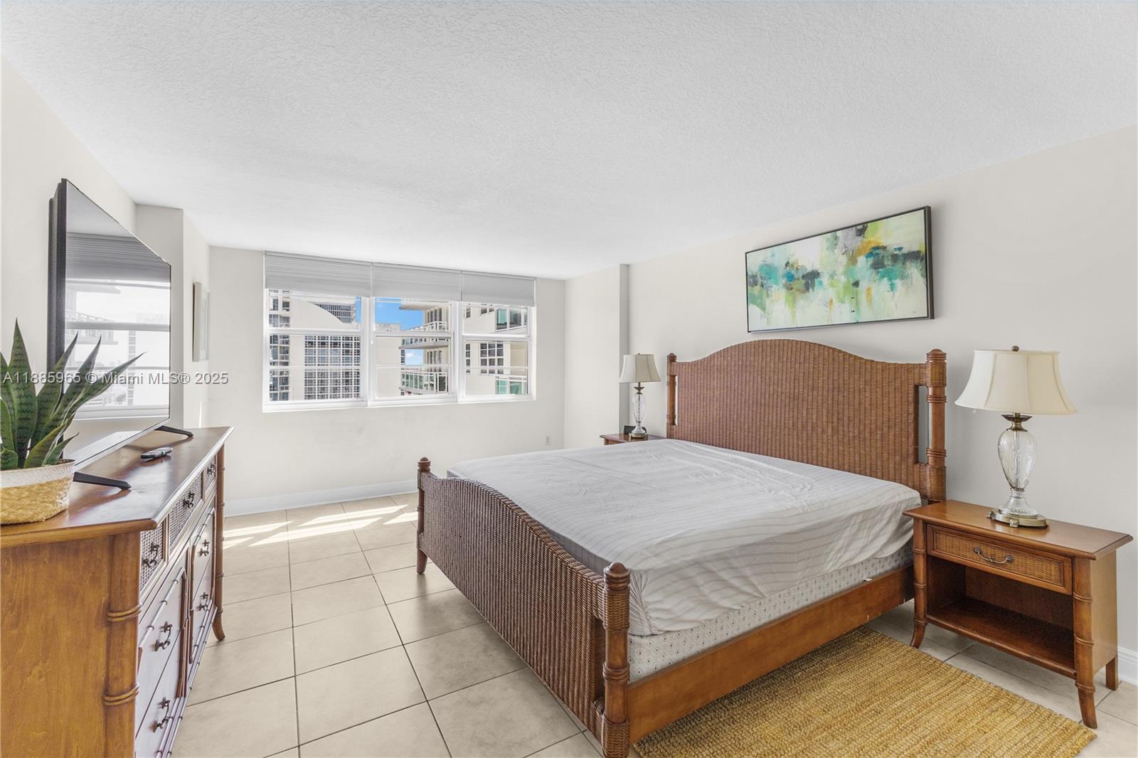 6917 Collins Avenue, Unit 1505 Miami Beach, FL 33141 - Photo 22 of 53 a bedroom with a bed and a window