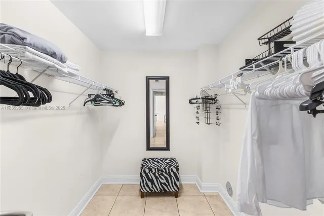 a large white kitchen with a large window and stainless steel appliances
