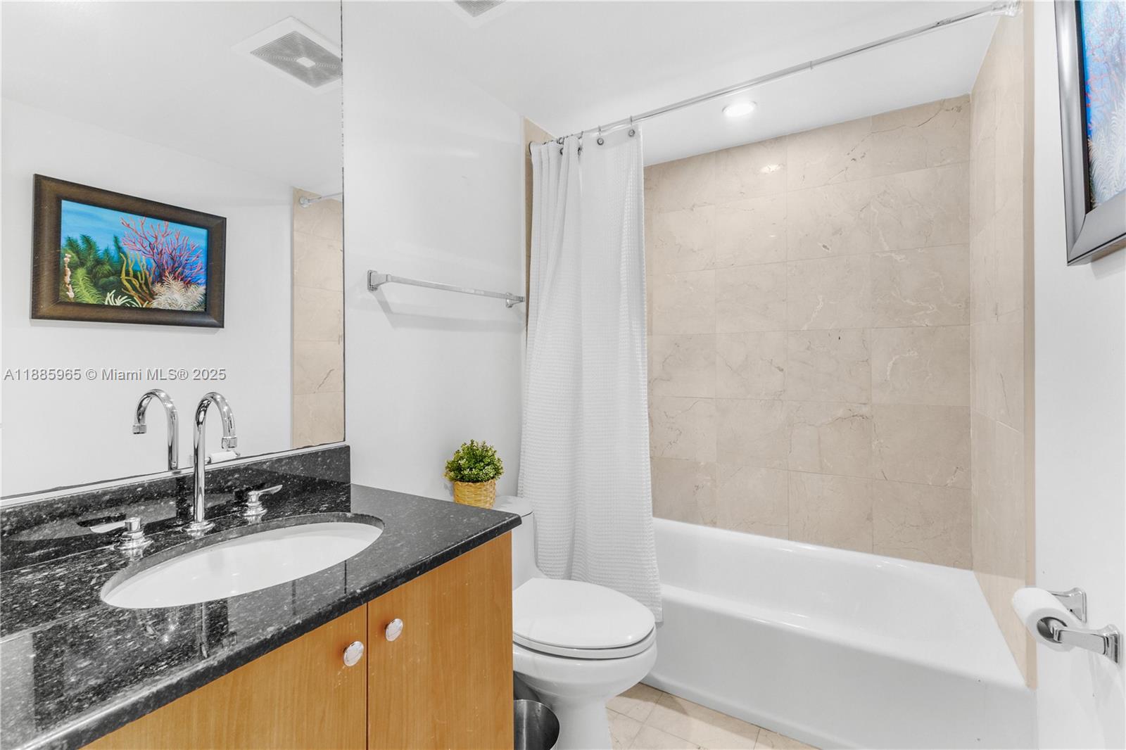 6917 Collins Avenue, Unit 1505 Miami Beach, FL 33141 - Photo 28 of 53 a bathroom with a granite countertop sink toilet and shower