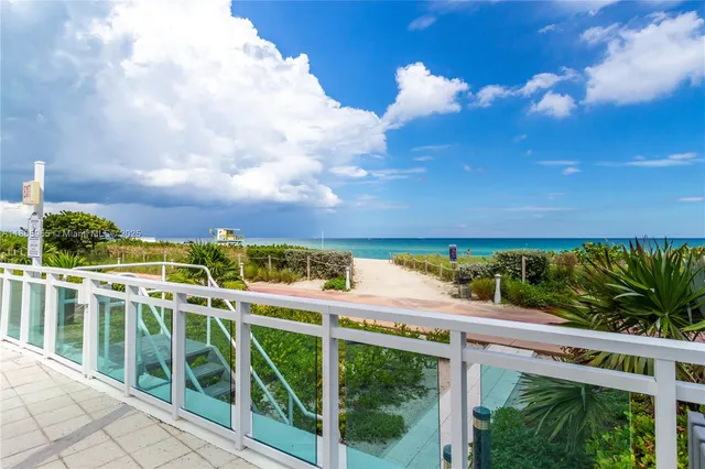 a view of swimming pool with outdoor seating and lake view