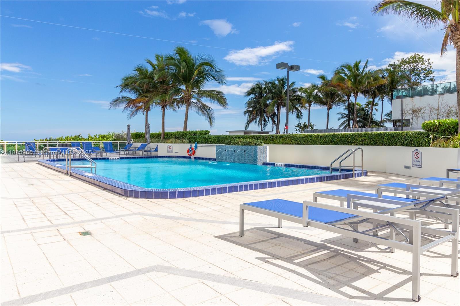 6917 Collins Avenue, Unit 1505 Miami Beach, FL 33141 - Photo 46 of 53 a view of swimming pool with outdoor seating and plants