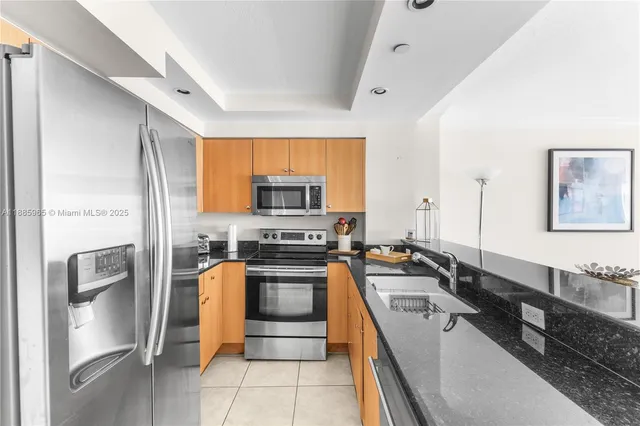 a kitchen with stainless steel appliances a stove sink and refrigerator