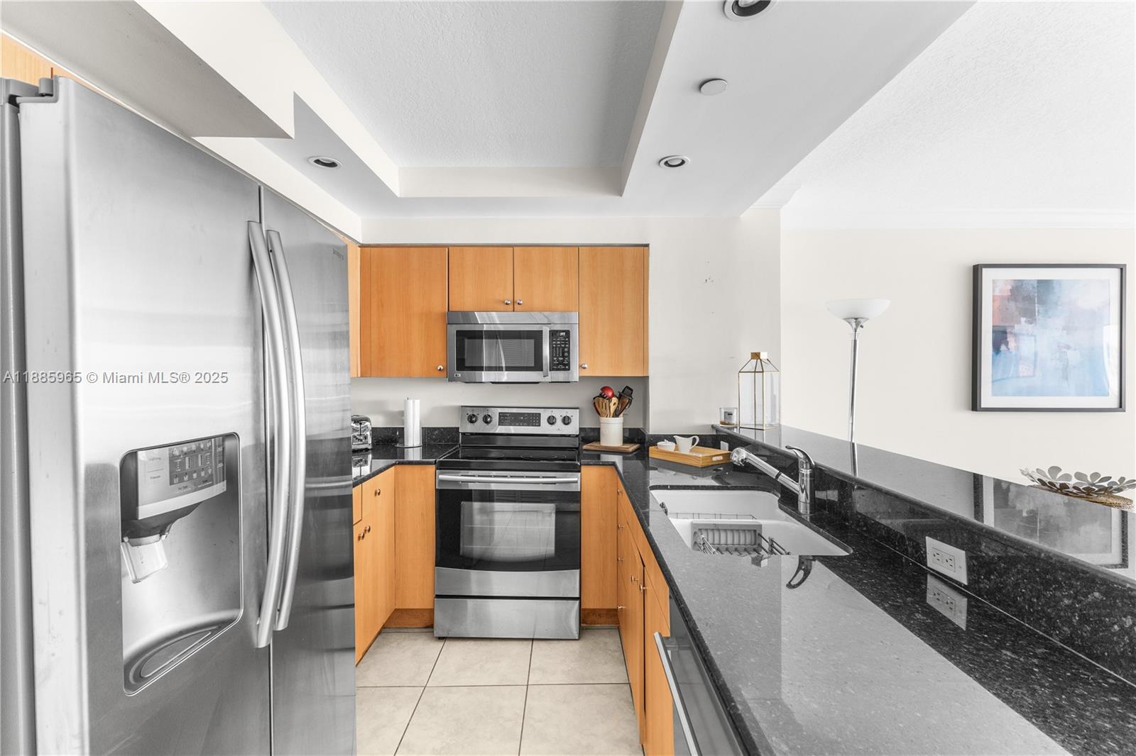 6917 Collins Avenue, Unit 1505 Miami Beach, FL 33141 - Photo 10 of 53 a kitchen with stainless steel appliances a stove sink and refrigerator